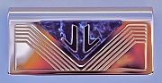 Initials “JL” on a panel for the interior of a private airplane as hand-pierced by Dwight H. Bennett.