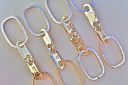 Four Sterling Silver Engravable Link-Lock Come-Apart key rings (and one with 14K gold disks) designed and hand-produced by Dwight H. Bennett.